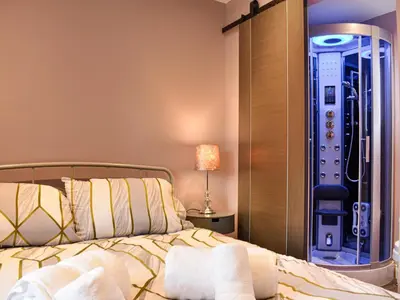 a bedroom with a bed and a walk in shower at Ivy House in Dockray