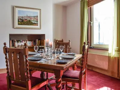 a dining room with a wooden table and chairs at Long Rose in Keswick