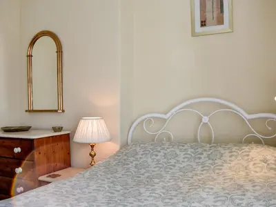 a bedroom with a bed and a dresser and a mirror at Long Rose in Keswick