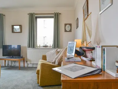 a living room with a couch and a table at Harbour Watch in Maryport
