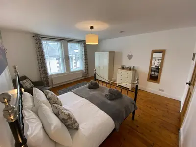 a bedroom with a large bed and a couch at Ridge View - Amazing Roof Terrace in Keswick