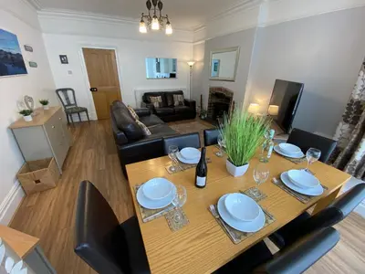 a dining room table and chairs in a living room at Ridge View - Amazing Roof Terrace in Keswick