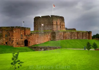 a castle on top of a lush green field at Luxury House Near City Center Hospital &Superstore in Carlisle