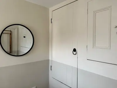 a bathroom with a mirror and a glass door at 1 The Croft in Cockermouth