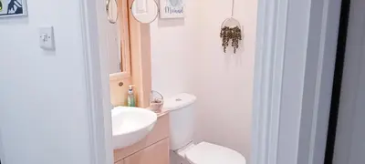 a white bathroom with a sink and a toilet at 24 The Zen Den Cumbria in High Hesket