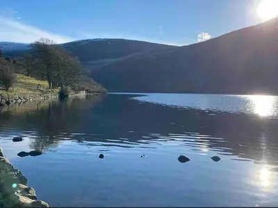 a view of a lake with mountains in the background at Teapot Cottage in Ennerdale - Hot tub Pizza Oven Log Burner in Cleator