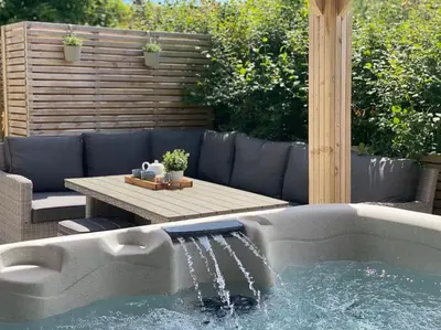 a swimming pool with a table and a tub at Teapot Cottage in Ennerdale - Hot tub Pizza Oven Log Burner in Cleator