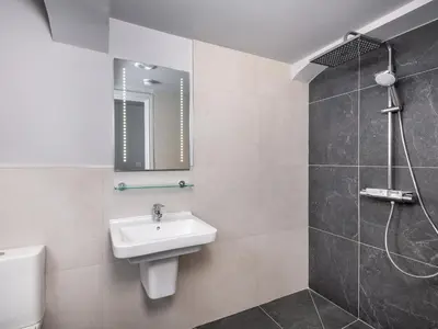 a bathroom with a sink and a shower at Apartment 1 Latrigg in Keswick