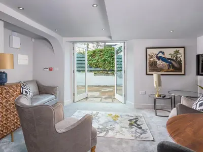 a living room with chairs and a table at Apartment 1 Latrigg in Keswick