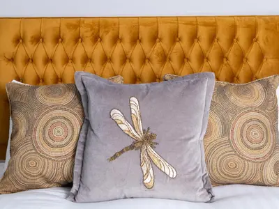 a pillow with a dragonfly on it sitting on a bed at Apartment 2 Blencathra in Keswick