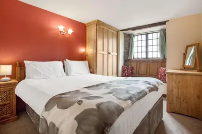 a bedroom with a large bed in a room at The Mountain Cottages - Carpenters in Coniston