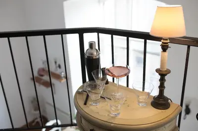 a table with wine glasses and a lamp on a balcony at Creathie Cathcart - Georgian Luxury at the beach in Ayr