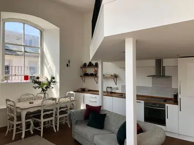 a living room and kitchen with a couch and a table at Creathie Cathcart - Georgian Luxury at the beach in Ayr