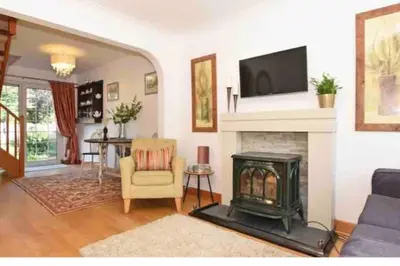 a living room with a fireplace and a tv on a wall at Best location in town, it is all on the doorstep. in Ayr