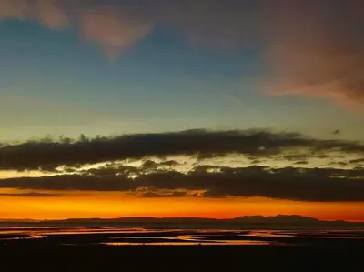 a sunset over a body of water with clouds at Best location in town, it is all on the doorstep. in Ayr