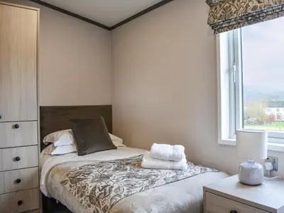 a small bedroom with a bed and a window at Dodd - Uk42499 in Bassenthwaite