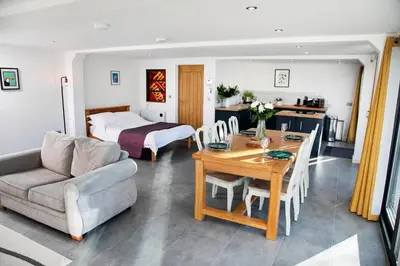 a living room with a table and a bed at Bird House - Sleep with the Owls! in Carlisle
