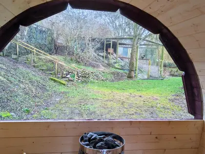 a window in a cabin looking out at a yard at Bird House - Sleep with the Owls! in Carlisle