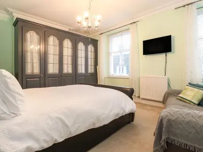 a bedroom with a bed and a flat screen tv at Blencathra in Keswick