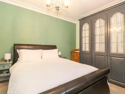 a bedroom with a bed and green walls at Blencathra in Keswick