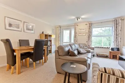 a living room with a couch and a table at Herdwick Place Langdale Valley in Great Langdale