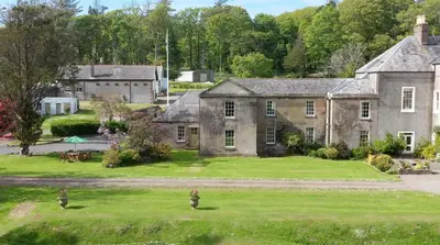 an aerial view of a large house with a yard at Garden Cottage in Stranraer