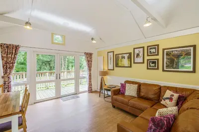 a living room with a couch and a table at Squirrel Lodge 41 with Hot Tub in Newton Stewart