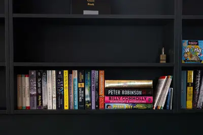 a book shelf filled with lots of books at Greta Howe in Keswick