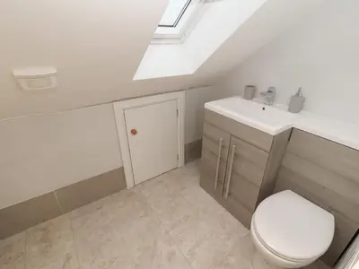 a bathroom with a toilet and a sink at Beckside House in Cockermouth