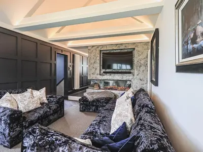 a living room with two couches and a television at Whisk Away Cottage in Penrith