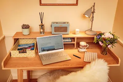 a desk with a laptop computer on top of it at Home Farm Cottage in Stranraer