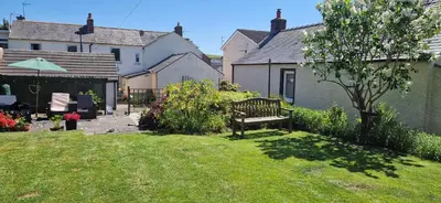 a park bench in the yard of a house at Mains Street Retreat in Lockerbie