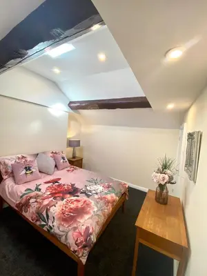 a bedroom with a bed and a wooden table at Mountain Dream Cottage in Ramsey