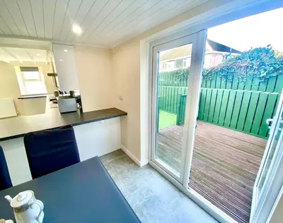 an office with a desk and a sliding glass door at Mountain Dream Cottage in Ramsey