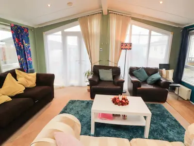 a living room with couches and a coffee table at Rosie's Zen Den in Carlisle