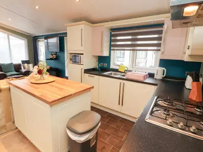 a kitchen with white cabinets and a counter top at Rosie's Zen Den in Carlisle