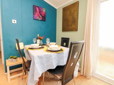 a dining room table with a white table cloth on it at Rosie's Zen Den in Carlisle