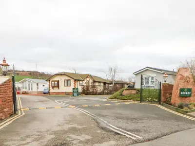 an empty street in a village with houses at Rosie's Zen Den in Carlisle