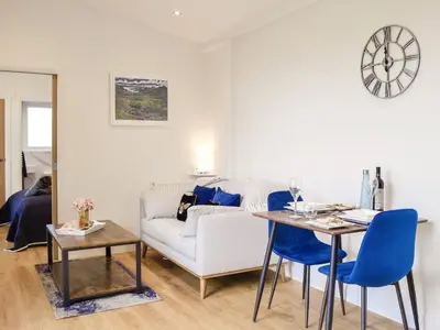 a living room with a couch and a table at Lime Tree Lodge in Castle Douglas