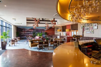 a restaurant with a bar and tables and chairs at 12 Ullswater Suite - Whitbarrow Village in Penruddock