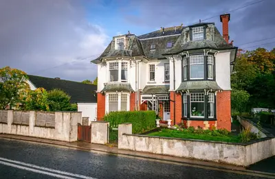 a large house on the side of a street at Spacious Ground Floor Apartment in Keswick