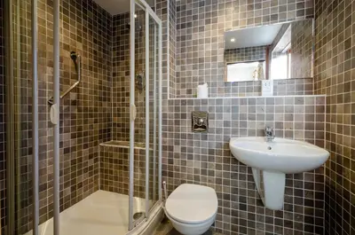 a bathroom with a toilet and a sink at Bens Cottage in Chapel Stile