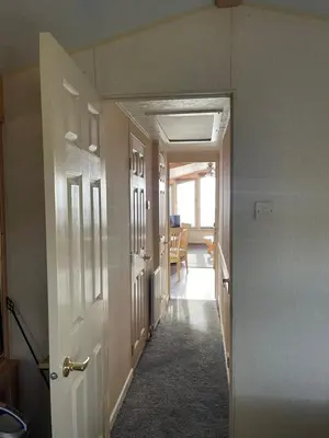 an empty hallway with a hallway leading to a room at Immaculate 2-Bed Static Caravan at Monrieth in Newton Stewart