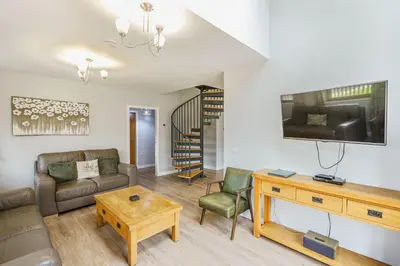 a living room with a couch and a table at Lord Galloway 32 with Hot Tub in Newton Stewart