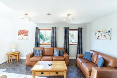 a living room with couches and a coffee table at Lord Galloway 34 with Hot Tub in Newton Stewart