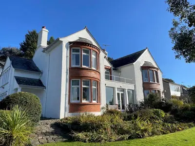 a large white house with a large window at Beautiful 4BR Period Home With Spectacular Views - Pass the Keys in Kippford