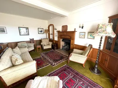a living room with a couch and a fireplace at Beautiful 4BR Period Home With Spectacular Views - Pass the Keys in Kippford