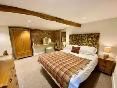 a bedroom with a large bed in a room at Stunning barn minutes from the Lake District in Penrith