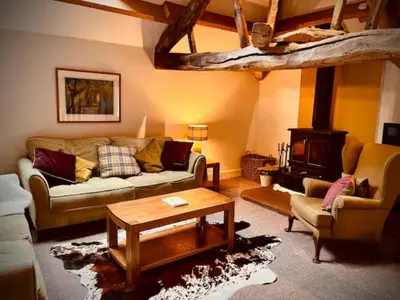 a living room with a couch and a table at Stunning barn minutes from the Lake District in Penrith