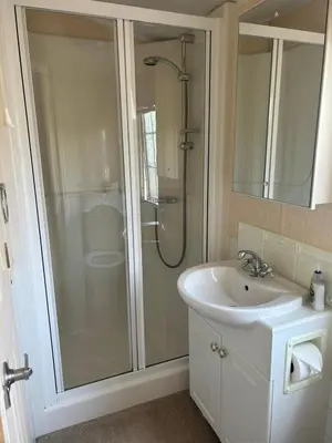 a bathroom with a shower and a sink at Stunning Caravan Whithorn3 in Newton Stewart